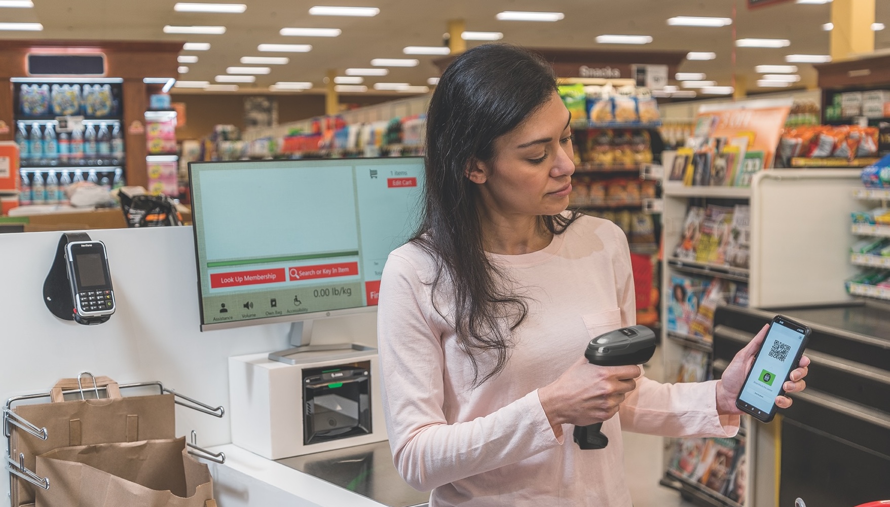 A woman uses Zebra scanner to scan a QR-code from a smartphone.